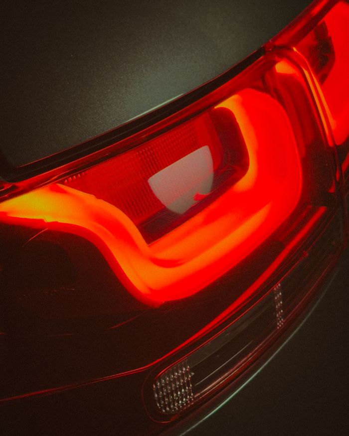 Detailed view of a sleek red LED tail light on a modern vehicle.
